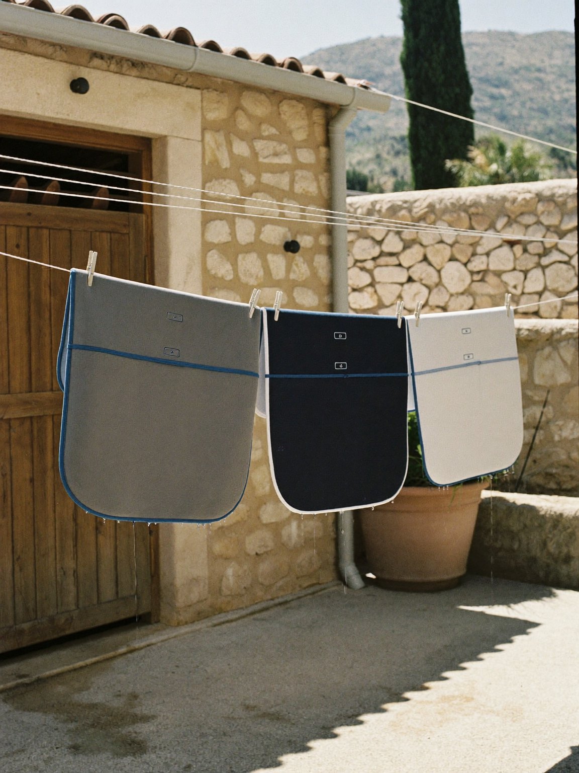 Saddle pads drying on a washing line at a Mallorca yard
