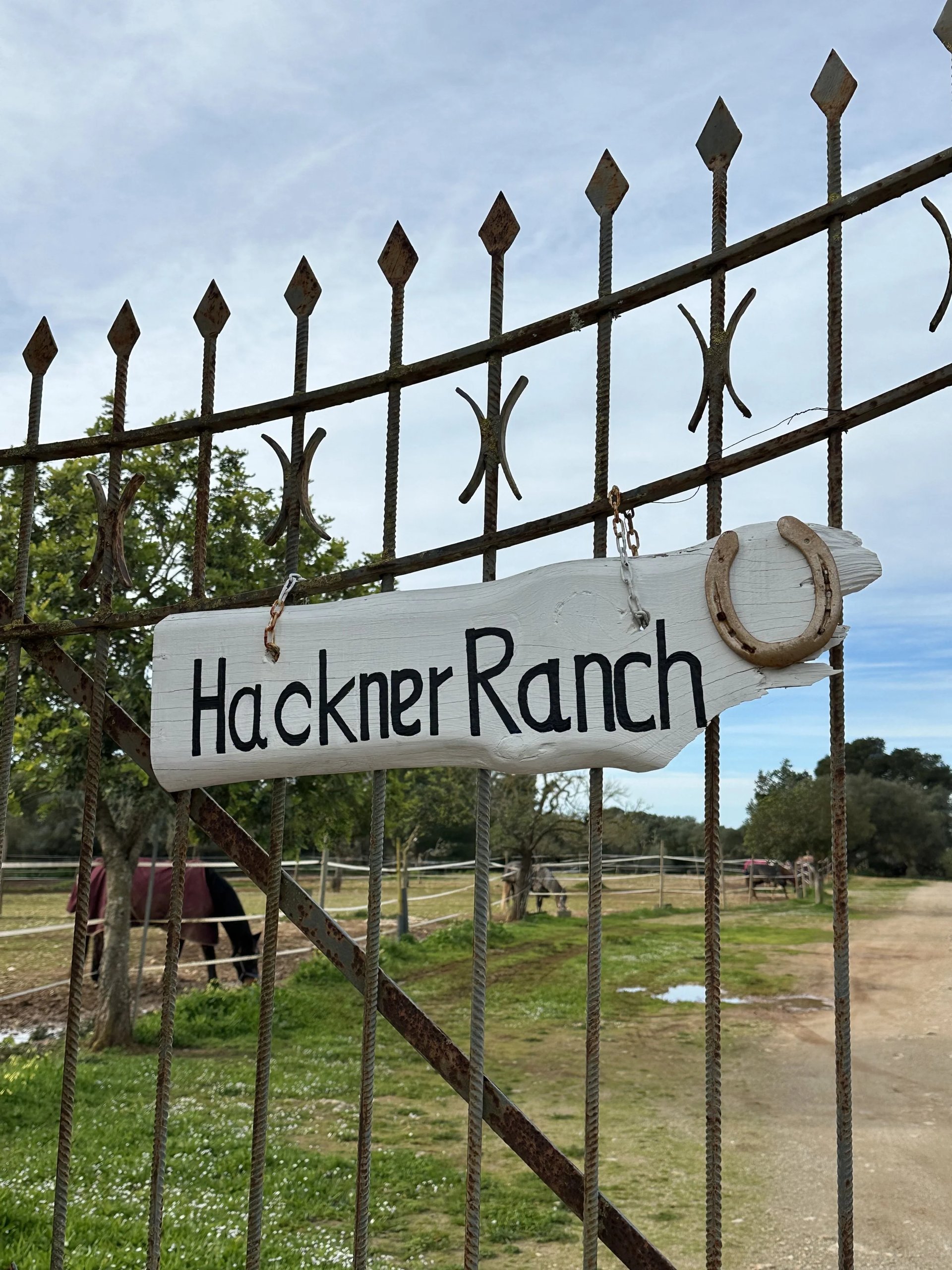 The wrought-iron gate with the Hackner Ranch sign in Algaida