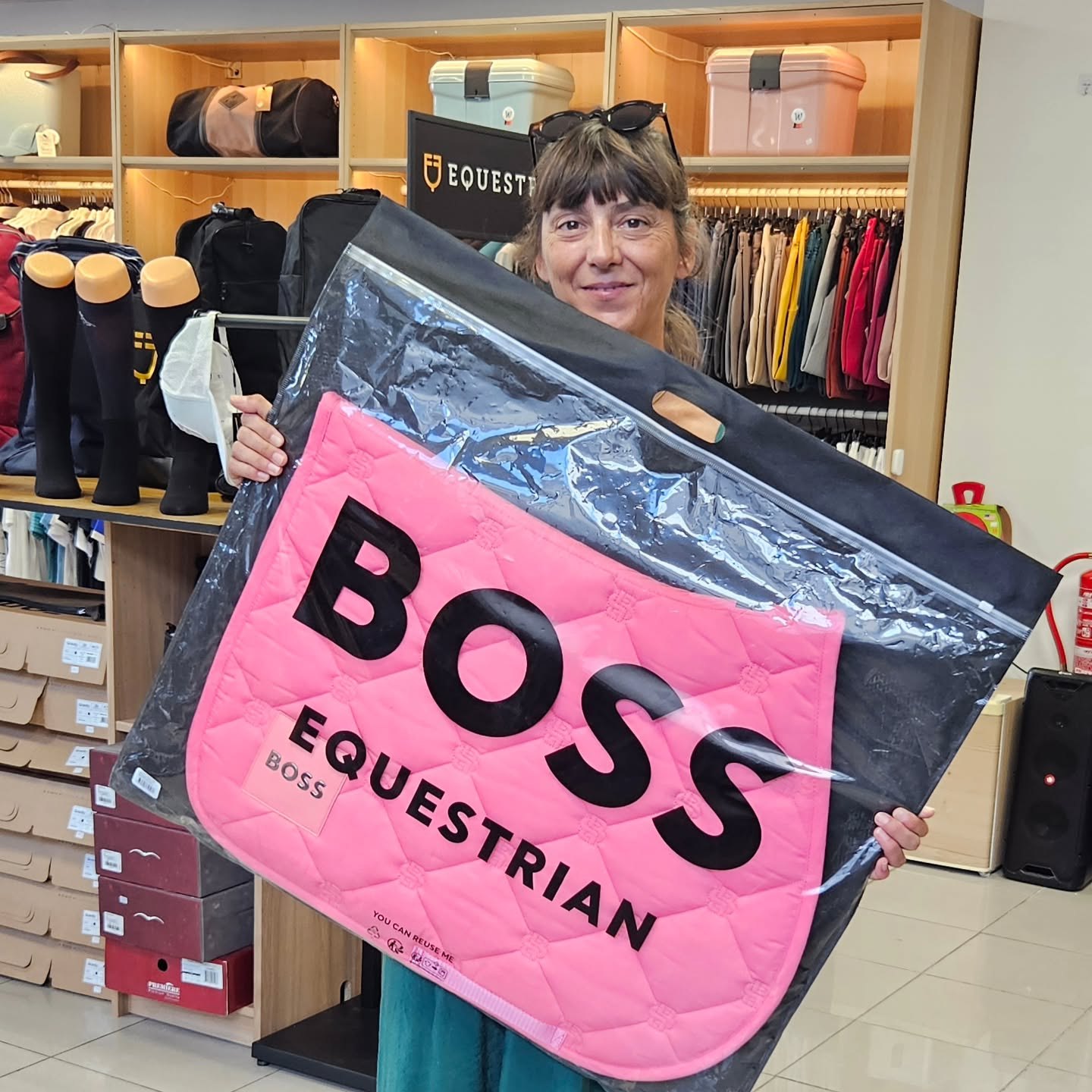 A team member showing a pink saddle pad