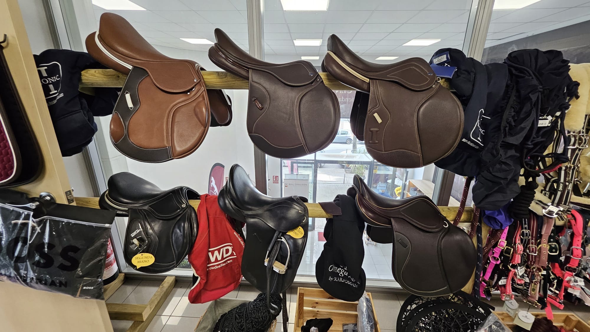 Jumping saddles on a rail in the shop