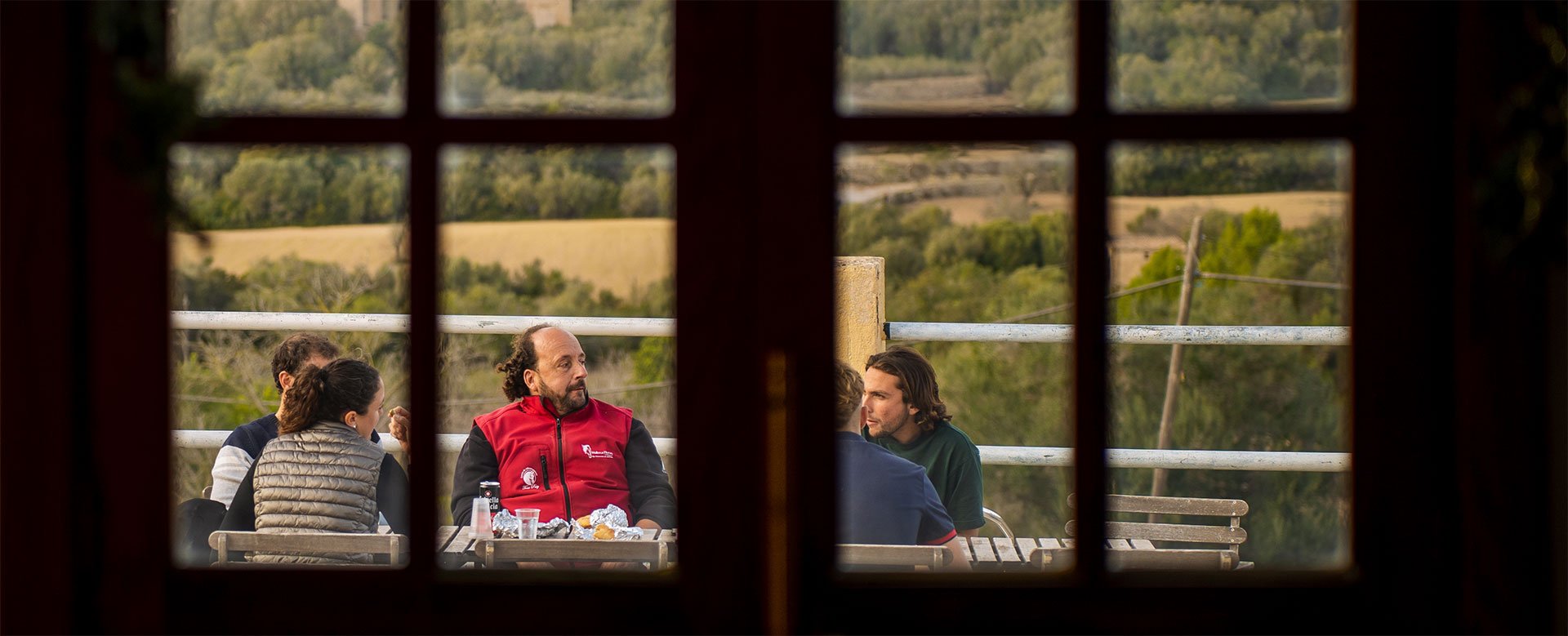 View through a window onto the terrace and the countryside of Randa