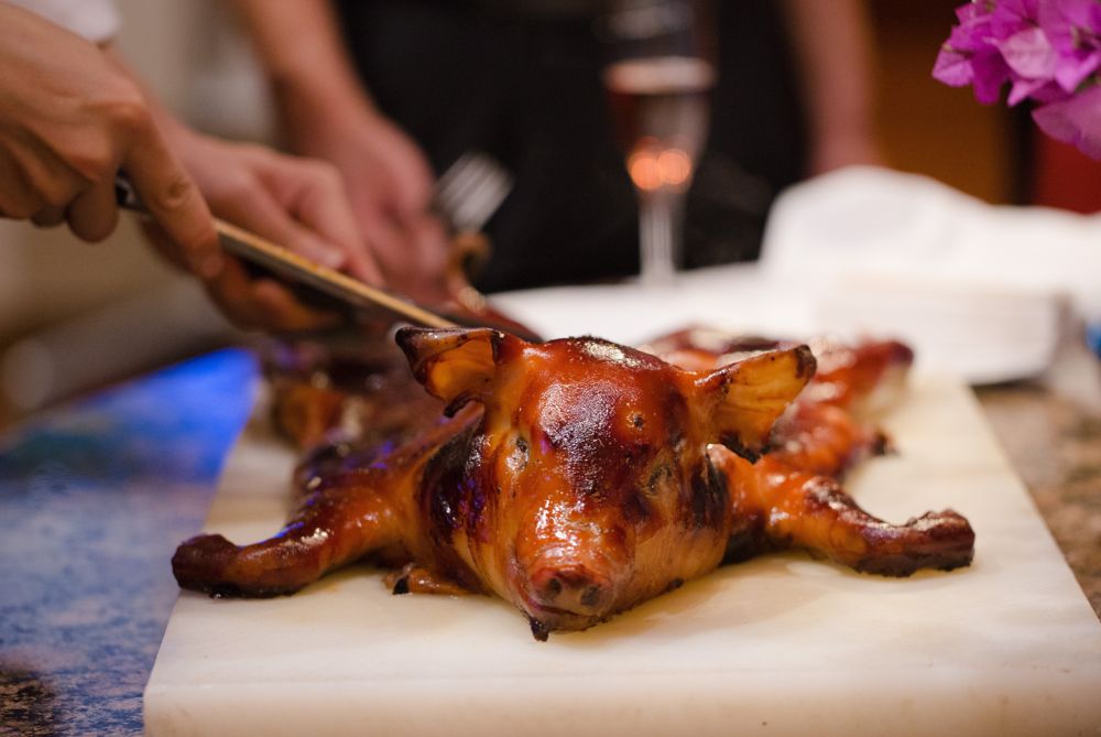 Roast suckling pig being carved